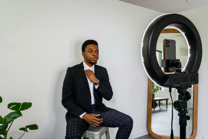 a man in a blazer vlogging